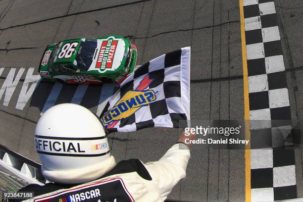 Kevin Harvick, driver of the Hunt Brothers Pizza Ford, takes the checkered flag to win the NASCAR Xfinity Series Rinnai 250 at Atlanta Motor Speedway...