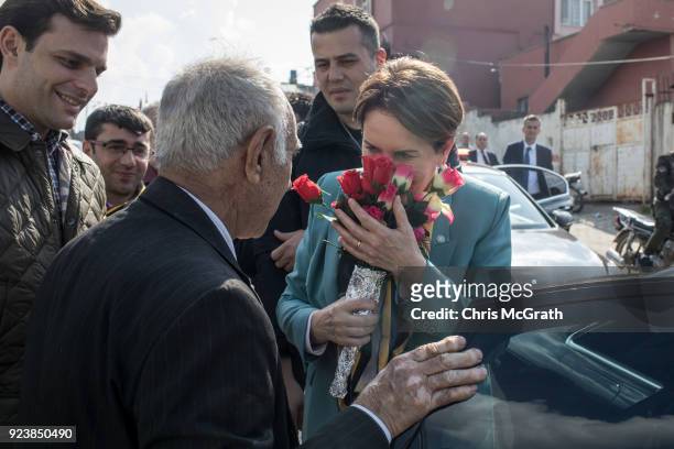 Man delivers flowers to IYI Party Chairman Meral Aksener during a stop on February 24, 2018 in Reyhanli, Turkey. Meral Aksener and party members...