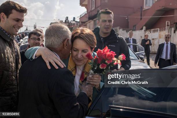 Man delivers flowers to IYI Party Chairman Meral Aksener during a stop on February 24, 2018 in Reyhanli, Turkey. Meral Aksener and party members...