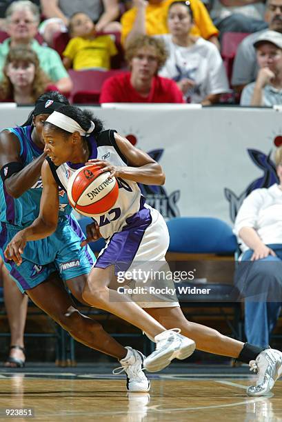 Guard Kedra Holland-Corn of the Sacramento Monarchs drives inside against guard Marie Ferdinand of the Utah Starzz on June 22, 2002 at Arco Arena in...