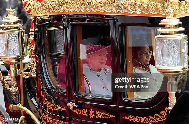 Britain's Queen Elizabeth II rides a carriage with the President of the Republic of India, Prathibha Devi Singh Patil, as she arrives for a State...