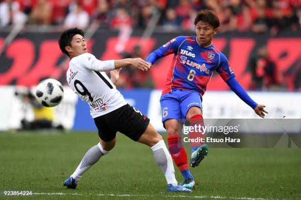 Kosuke Ota of FC Tokyo and Yuki Muto of Urawa Red Diamonds compete for the ball during the J.League J1 match between FC Tokyo and Urawa Red Diamonds...