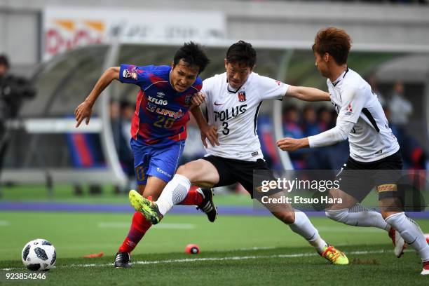 Ryoichi Maeda of FC Tokyo and Tomoya Ugajin of Urawa Red Diamonds compete for the ball during the J.League J1 match between FC Tokyo and Urawa Red...