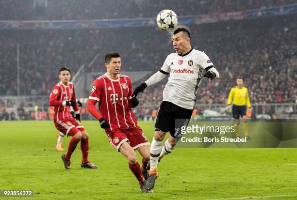Gary Medel of Besiktas Istanbul jumps for a header with Robert Lewandowski of FC Bayern Muenchen during the UEFA Champions League Round of 16 First...