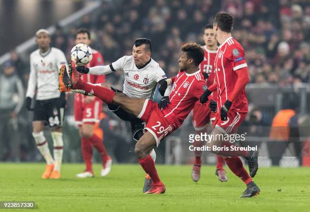 Kingsley Coman of FC Bayern Muenchen is challenged by Gary Medel of Besiktas Istanbul during the UEFA Champions League Round of 16 First Leg match...