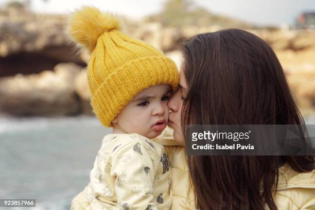 sister kissing baby brother - costa_del_azahar stock pictures, royalty-free photos & images