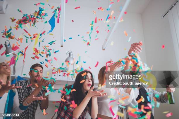 blowing confetti on party - birthday surprise stock pictures, royalty-free photos & images