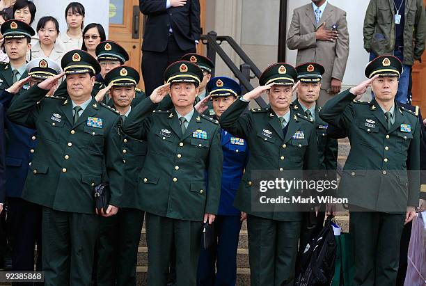 Members of the Chinese military delegation salute while Secretary of Defense Robert M. Gates and the People's Republic of China Central Military...