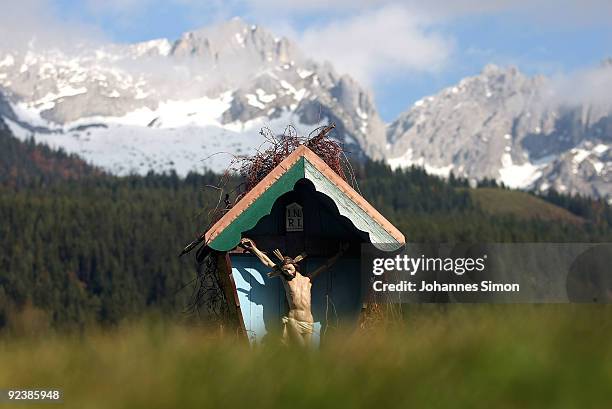Traditional Alpine depiction of Christ on the cross is seen in front of the Wilder Kaiser mountains on October 27, 2009 in Ellmau, Austria.