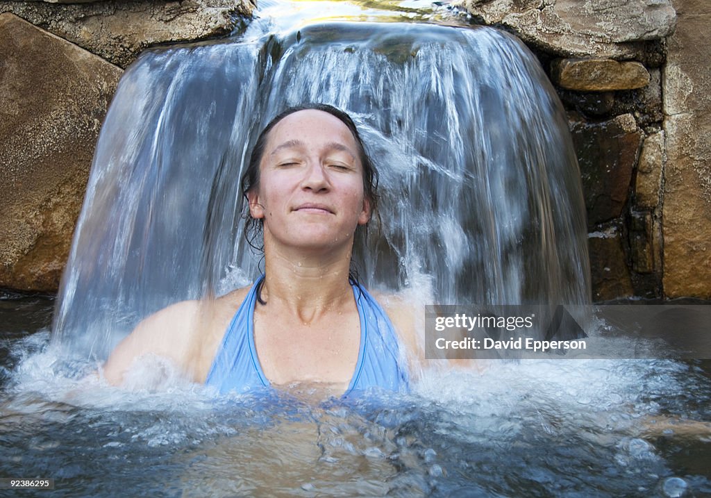 Woman relaxing in natural hot springs