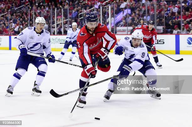 Matt Niskanen of the Washington Capitals battles for the puck against Tyler Johnson of the Tampa Bay Lightning in the first period at Capital One...