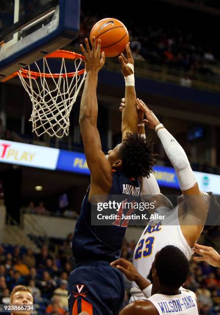 Ty Jerome of the Virginia Cavaliers puts in a rebound against Shamiel Stevenson of the Pittsburgh Panthers at Petersen Events Center on February 24,...