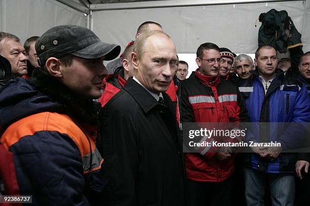 Russian Prime Minister Vladimir Putin meets with workers during the inaugeration of a new road October 27, 2009 near Kaliningrad in the Western...