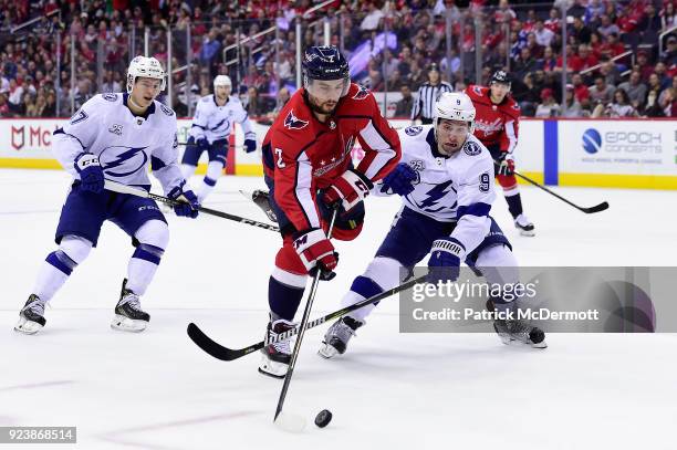 Matt Niskanen of the Washington Capitals battles for the puck against Tyler Johnson of the Tampa Bay Lightning in the first period at Capital One...