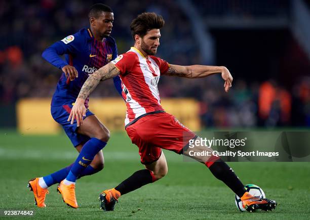 Nelson Semedo of Barcelona competes for the ball with Carles Planas of Girona during the La Liga match between Barcelona and Girona at Camp Nou on...