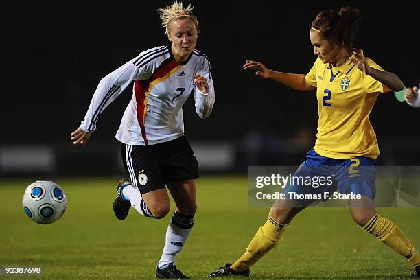 Turid Knaak of Germany and Isabell Viksell of Sweden tackle for the ball during the women's international friendly match between Germany U19 and...