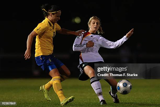 Josefine Alfsson of Sweden and Kathrin-Julia Hendrich of Germany tackle for the ball during the women's international friendly match between Germany...