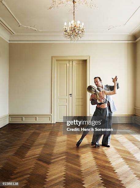 adult couple dancing in empty interior - elegant couple stockfoto's en -beelden