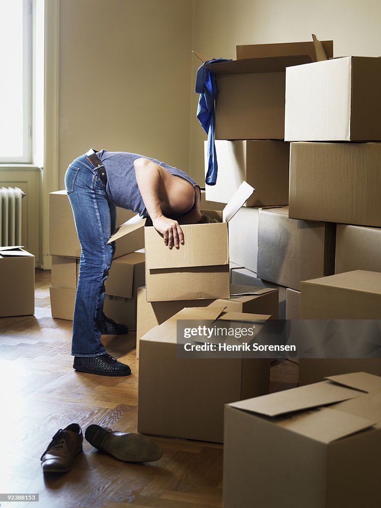 Adult male searching in moving crate