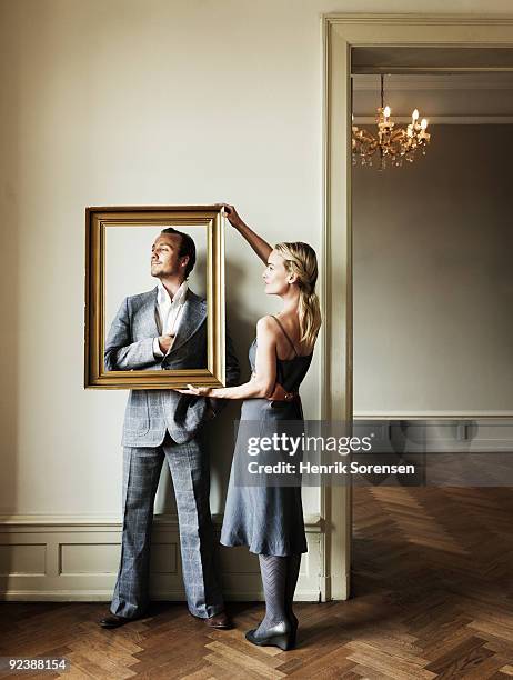 adult female framing partner against a wall - överklass bildbanksfoton och bilder