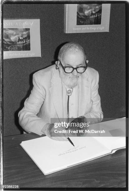 American photographer Ansel Adams signs a copy of his book 'Yosemite and the Range of Light,' October 1, 1979.