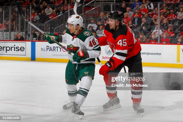 Jared Spurgeon of the Minnesota Wild in action against Sami Vatanen of the New Jersey Devils on February 22, 2018 at Prudential Center in Newark, New...