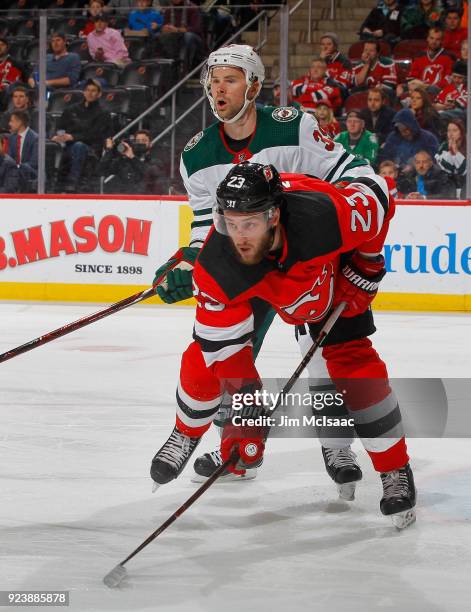 Stefan Noesen of the New Jersey Devils in action against Nate Prosser of the Minnesota Wild on February 22, 2018 at Prudential Center in Newark, New...