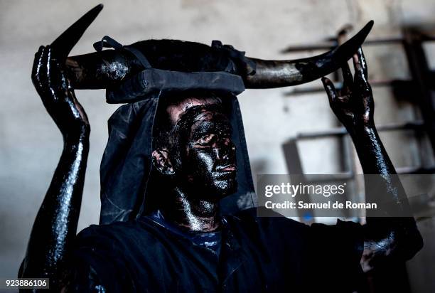 People sporting horns on their heads and grease on their faces perform as 'Diablos de Luzon' during the carnaval in Luzon, near Guadalajara, on...
