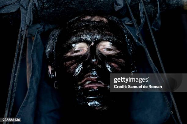 People sporting horns on their heads and grease on their faces perform as 'Diablos de Luzon' during the carnaval in Luzon, near Guadalajara, on...