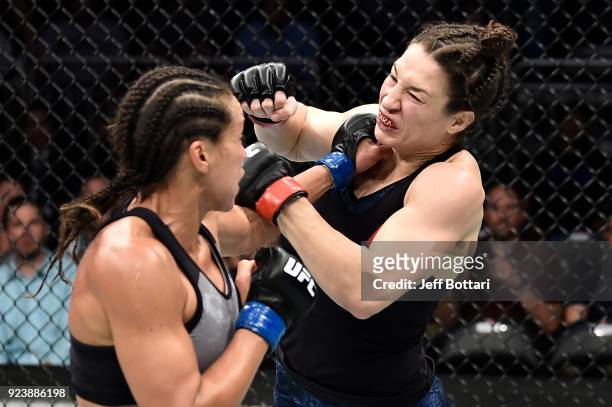 Marion Reneau punches Sara McMann in their women's bantamweight bout during the UFC Fight Night event at Amway Center on February 24, 2018 in...