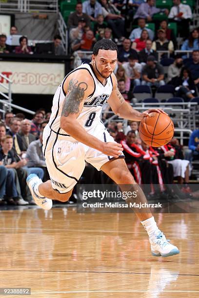 Deron Williams of the Utah Jazz drives the ball up court during a preseason game against the Portland Trail Blazers at the EnergySolutions Arena on...