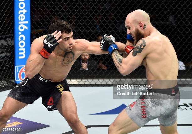 Renan Barao of Brazil punches Brian Kelleher in their bantamweight bout during the UFC Fight Night event at Amway Center on February 24, 2018 in...