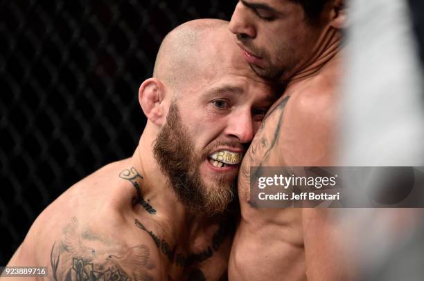 Brian Kelleher grapples with Renan Barao of Brazil against the cage in their bantamweight bout during the UFC Fight Night event at Amway Center on...