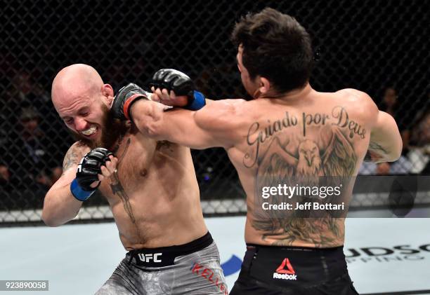 Brian Kelleher and Renan Barao of Brazil trade punches in their bantamweight bout during the UFC Fight Night event at Amway Center on February 24,...