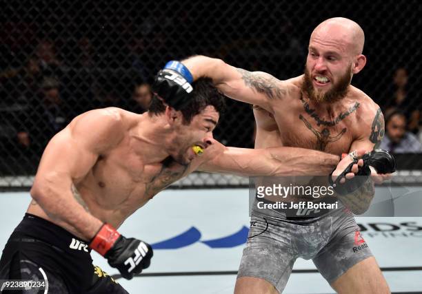 Brian Kelleher punches Renan Barao of Brazil in their bantamweight bout during the UFC Fight Night event at Amway Center on February 24, 2018 in...