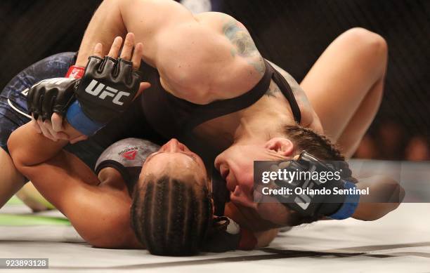 Sara McMann, top, and Marion Reneau fight during UFC Fight Night at the Amway Center in Orlando, Fla., on Saturday, Feb 24, 2018.