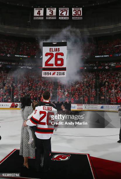 Former New Jersey Devils forward Patrik Elias and his family look on as his jersey is lifted to the rafters during the ceremony to retire the jersey...