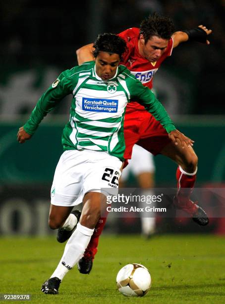 Sami Allagui of Greuther Fuerth is challenged by Christian Traesch of Stuttgart during the DFB Cup match between SpVgg Greuther Fuerth and VfB...