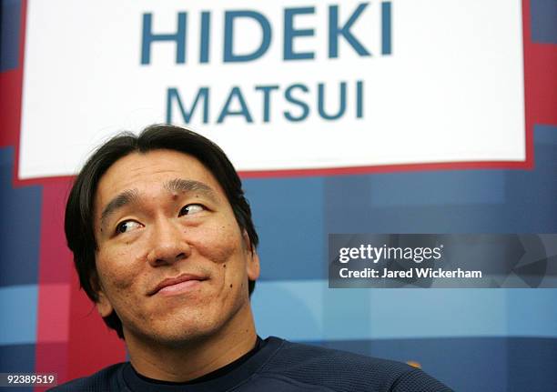 Hideki Matsui of the New York Yankees talks to members of the media before the World Series workouts on October 27, 2009 at Yankee Stadium in the...