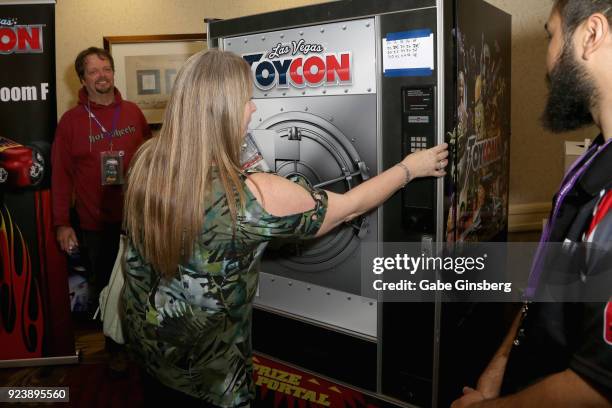 Karen Cunningham of Ohio opperates the Hot Wheels Vending Machine during Vegas Toy Con at the Circus Circus Las Vegas on February 24, 2018 in Las...