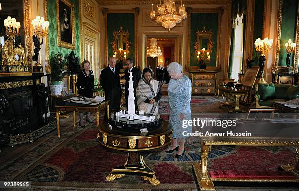 Queen Elizabeth ll, the President of India Pratibha Patil, Prince Philip, Duke of Edinburgh and Dr. Shekhawat view an exhibition of items in the...