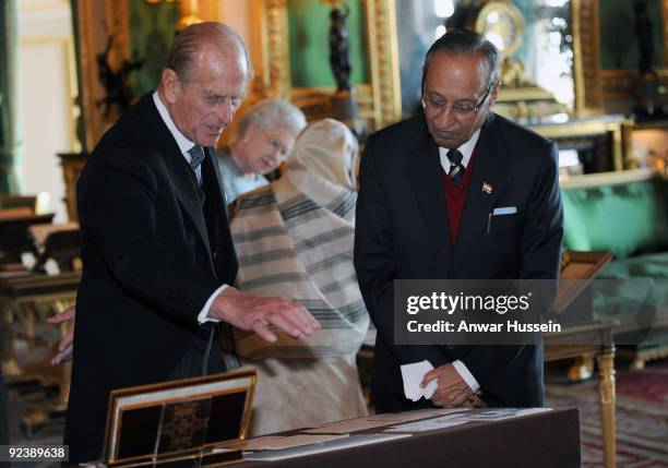 Queen Elizabeth ll, the President of India Pratibha Patil, Prince Philip, Duke of Edinburgh and Dr. Shekhawat view an exhibition of items in the...