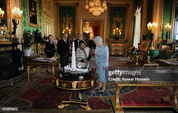 Queen Elizabeth ll, the President of India Pratibha Patil, Prince Philip, Duke of Edinburgh and Dr. Shekhawat view an exhibition of items in the...