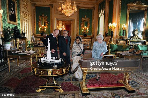 Queen Elizabeth ll, the President of India Pratibha Patil, Prince Philip, Duke of Edinburgh and Dr. Shekhawat view an exhibition of items in the...