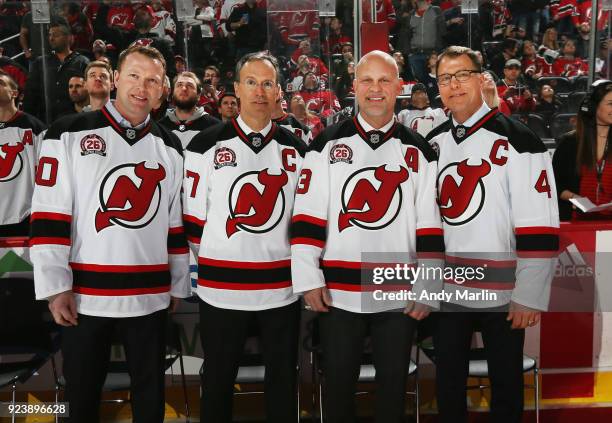 Former New Jersey Devils players Martin Brodeur, Scott Niedermayer, Ken Daneyko and Scott Stevens pose for a photo during the ceremony to retire...