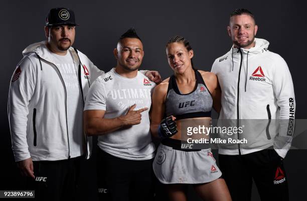 Marion Reneau poses for a portrait backstage with her team after her victory over Sara McMann during the UFC Fight Night event at Amway Center on...