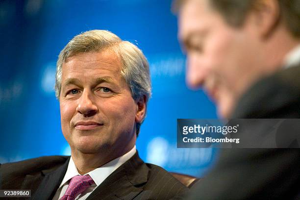Jamie Dimon, chairman and chief executive officer of JP Morgan Chase & Co., left, speaks with broadcaster Charlie Rose at the annual meeting of the...