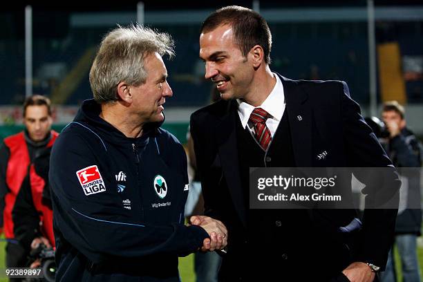 Head coach Benno Moehlmann of Greuther Fuerth shakes hands with head coach Markus Babbel of Stuttgart before the DFB Cup match between SpVgg Greuther...