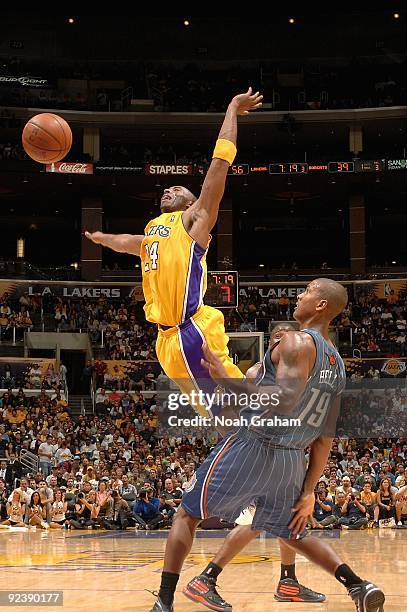 Kobe Bryant of the Los Angeles Lakers loses control of the ball under pressure from Raja Bell of the Charlotte Bobcats during the preseason game on...