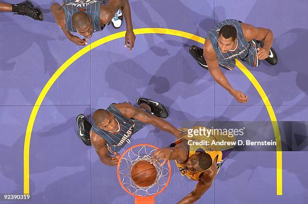Andrew Bynum of the Los Angeles Lakers goes to the basket over Raja Bell, Boris Diaw and Nazr Mohammed of the Charlotte Bobcats during the preseason...